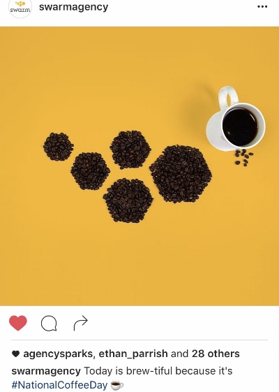 Swarm Agency honoring #NationalCoffeeDay by arranging coffee beans to mirror the design of their logo.